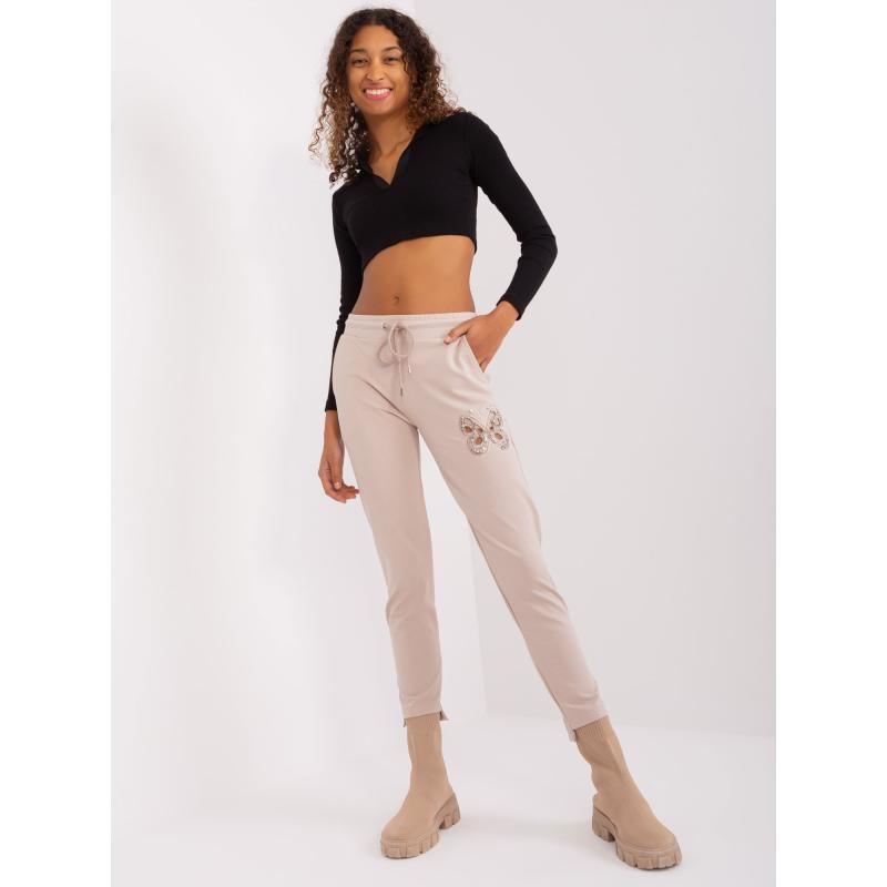 Dámské tepláky s průstřihy DIJ světle béžové 