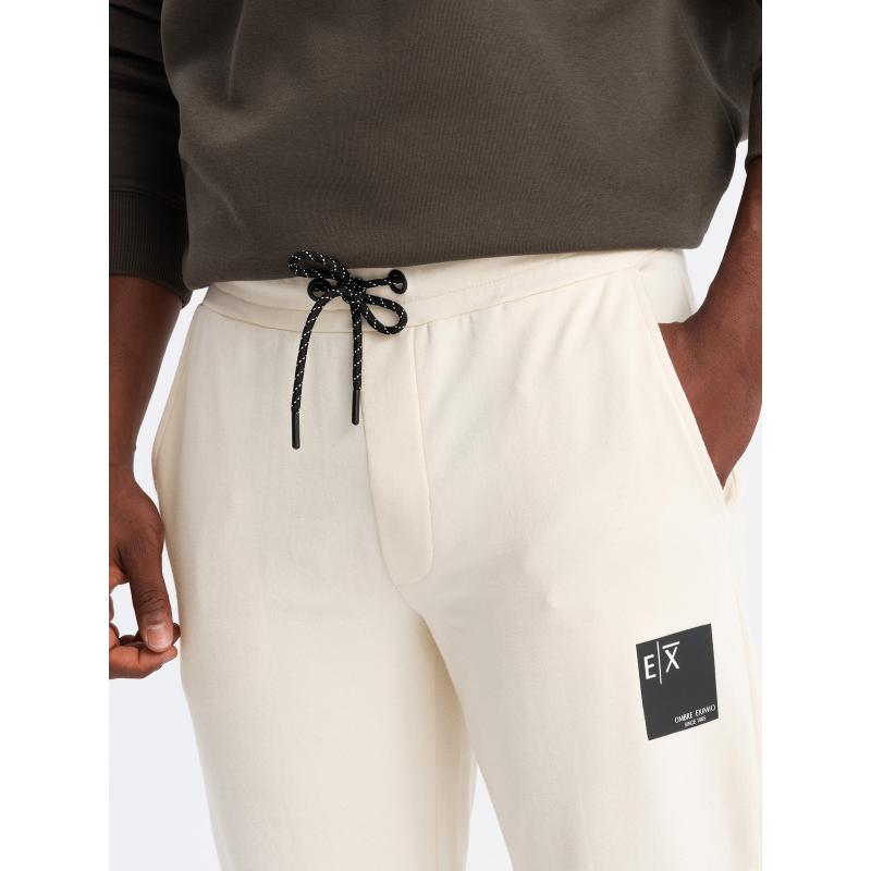 Pánské tepláky s logem krémové 