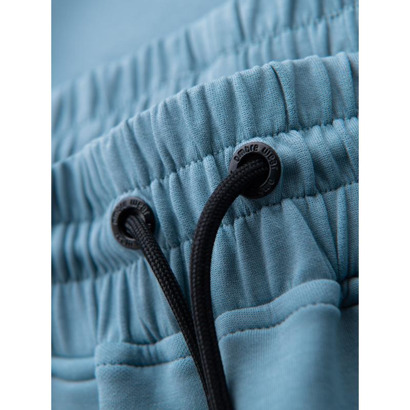 Férfi melegítőnadrág bordás szegéllyel és díszes cipzárral - világoskék V4 OM-PASK-0226