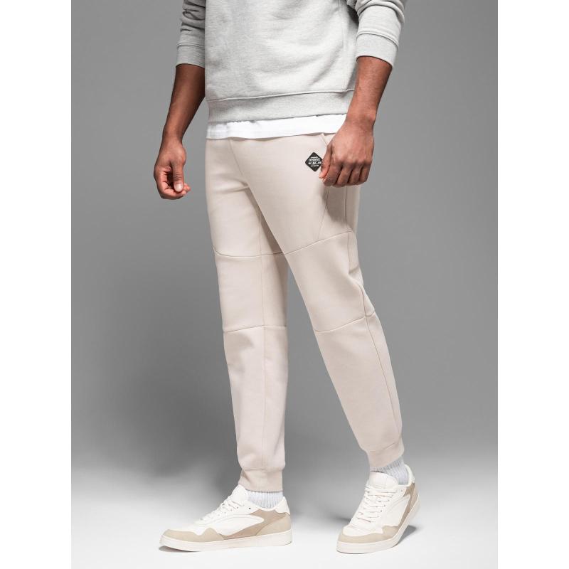 Pánské tepláky s žebrovanými manžetami a ozdobným zipem - pískové V6 OM-PASK-0226