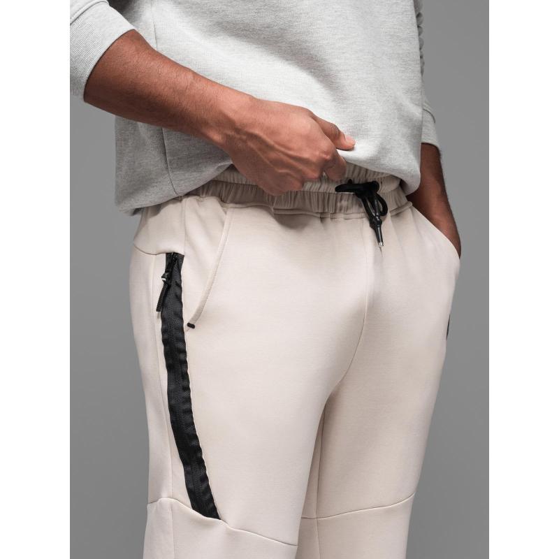 Pánské tepláky s žebrovanými manžetami a ozdobným zipem - pískové V6 OM-PASK-0226