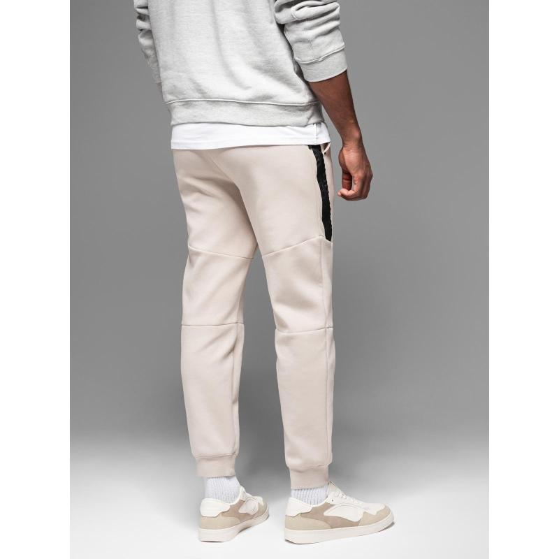 Pánské tepláky s žebrovanými manžetami a ozdobným zipem - pískové V6 OM-PASK-0226