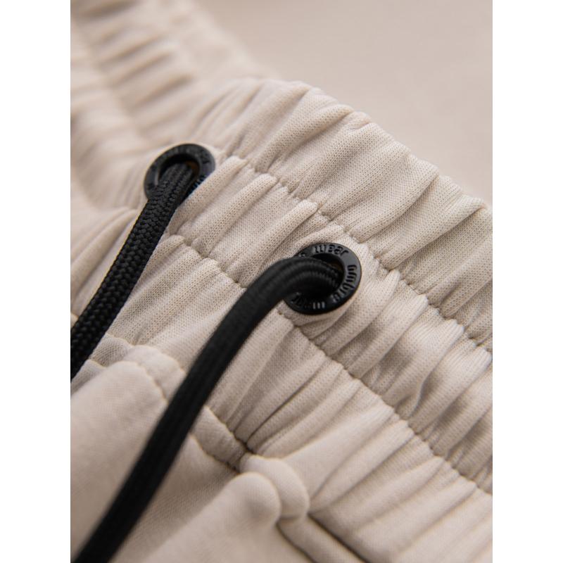 Pánské tepláky s žebrovanými manžetami a ozdobným zipem - pískové V6 OM-PASK-0226
