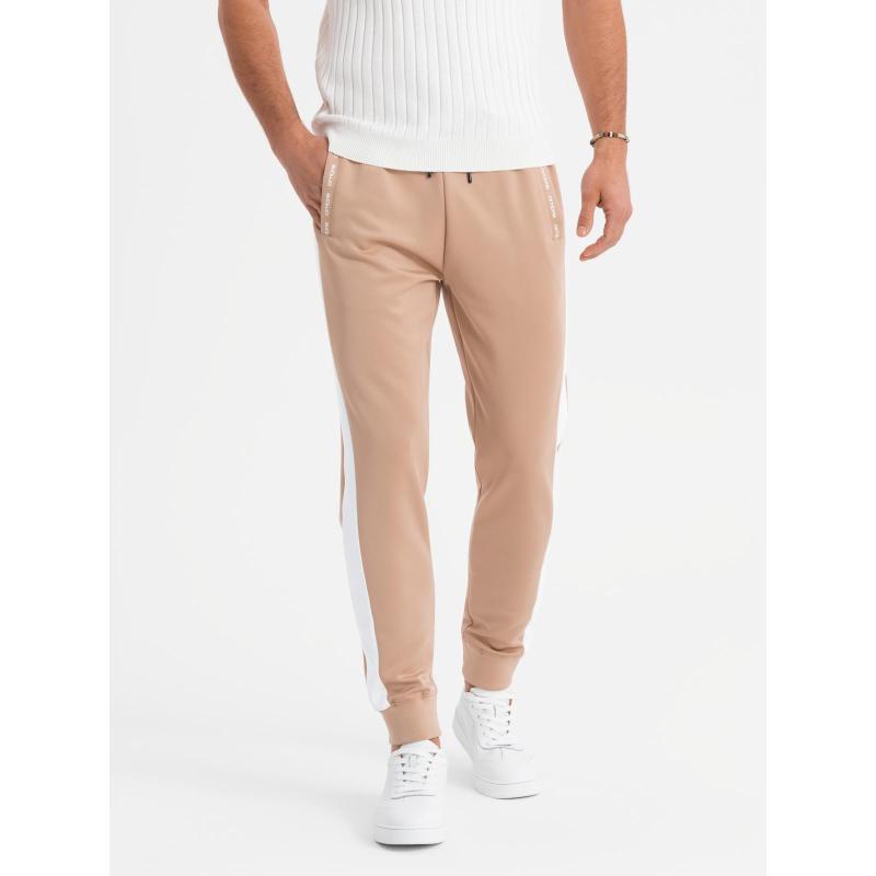 Férfi melegítőnadrág bordás szegélyű és díszes cipzárral - homok V6 OM-PASK-0226