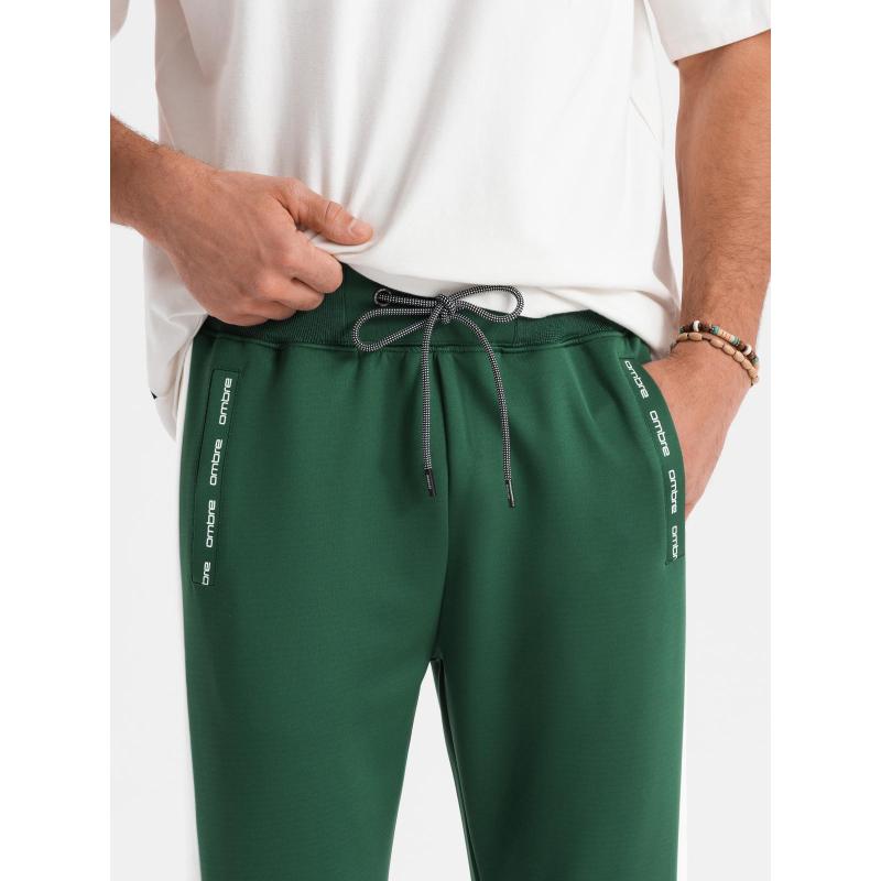 Pánske tepláky s rebrovanými manžetami a ozdobným zipsom - pieskové V6 OM-PASK-0226