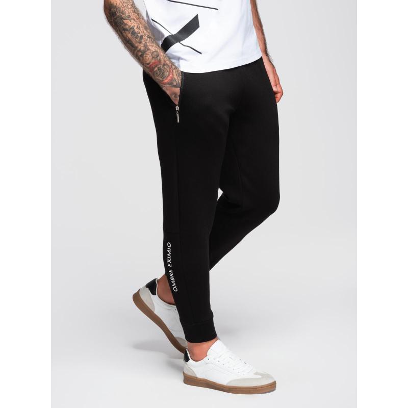 Pánské tepláky s žebrovanými nohavicemi a gumovým potiskem – černé V1 OM-PASK-0223